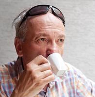 anciano bebiendo una taza de cafe foto