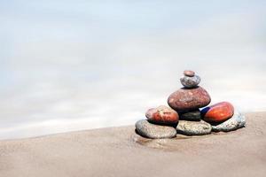 The heap of stones on a sandy beach photo