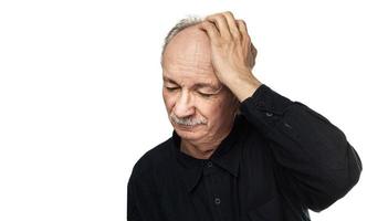 Elderly man suffers from headache photo