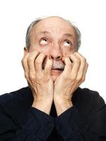 Elderly man suffers from headache photo