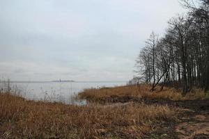 lake shore in autumn, view of the island on the horizon, landscape photo