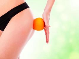 female backside with an orange, green blurred background photo