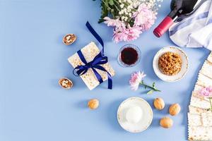 festive background of the Jewish Passover. traditional symbols and products of the holiday on a blue background. top view. flat layout. a copy space. photo