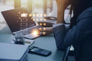 Customer service experience. Casual Businessman choosing screen on five star icon to give satisfaction in service, Customer service and Satisfaction concept, rating very impressed. photo