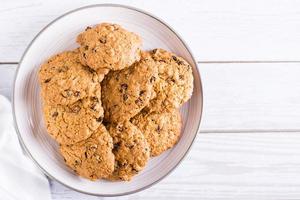Homemade oatmeal raisin cookies  on a plate. Healthy baking. Top view. Copy space photo