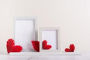 dos marcos de fotos en blanco decorados con corazones de papel diy. decoración del hogar.