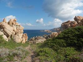 Clear amazing azure coloured sea water with granite rocks photo