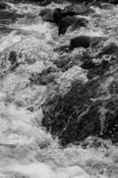 river flows over rocks - black and white stock photo. 2 photo