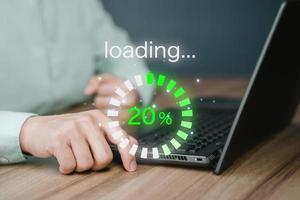 Man using laptop for download software and waiting to loading digital business data form website, concept of waiting for load of loading bar. photo