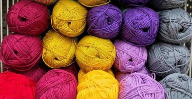 Colorful of Yarn Balls Wool in a Fabric Shop. Background from colored acrylic yarn. Skeins of thread close-up. Materials for needlework, for knitting and crocheting. photo