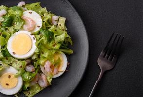 Delicious fresh healthy salad with shrimp, egg, lettuce and flax seeds photo