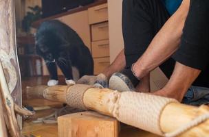 Man making climbing tree for cat at home. Cat tree - device for activity of domestic cat. photo