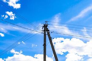 Power electric pole with line wire on colored background close up photo