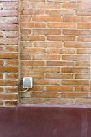 the power outlet is in a city park with red brick walls photo