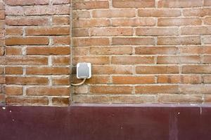 the power outlet is in a city park with red brick walls photo