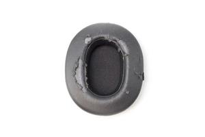 broken headphone pad from frequent use isolated on a white background. photo