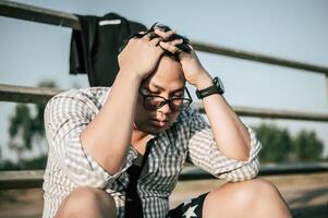 Young Asian Businessman with problems and stress outside corporate office photo