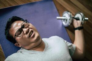 Funny fat man workout with dumbbell photo