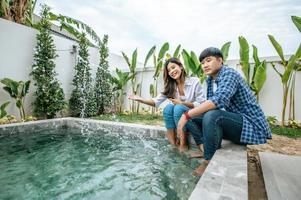 Happily Young couple enjoy talking together at swimming pool photo