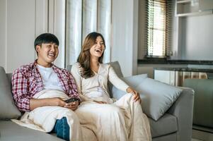 Attraction Young couple relaxing to watching TV at home photo