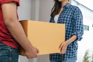 Young couple moving package into new house photo