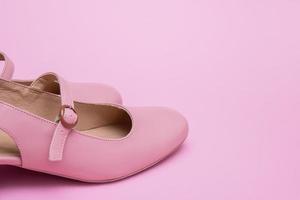 pink women's shoes on a pink background with copy space photo