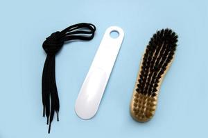 laces, horn and brush for shoes on a blue background, accessories for shoes