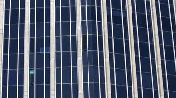 Modern building with blue glass windows reflected sky. Background in horizontal format photo