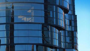 Modern building with glass windows reflected sky. Background in horizontal format photo