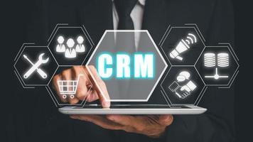 CRM Customer Relationship Management Business Internet Techology Concept, Businessman hand touching customer Relationship Management icon on VR creen. photo