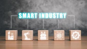 Smart industry 4.0 concept, Wooden block on desk with smart industry icon on virtual screen. photo