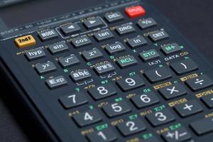 Scientific calculator isolated on black paper background photo