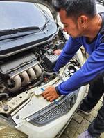 Central Java, Indonesia in October 2022. An officer is carrying out a physical check of a vehicle that will extend or replace its license plate number. photo