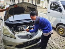 Central Java, Indonesia in October 2022. An officer is carrying out a physical check of a vehicle that will extend or replace its license plate number. photo