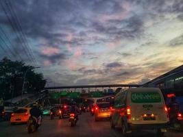 Jakarta, Indonesia in July 2022. Dusk on the road in Jakarta, where the traffic is quite congested because it coincides with work hours. photo