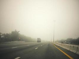 Road in the fog, sign mention keep distance for Motorway-t7.svg photo