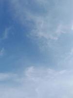 Beautiful white clouds on deep blue sky background. Elegant blue sky picture in daylight. Large bright soft fluffy clouds are cover the entire blue sky. photo