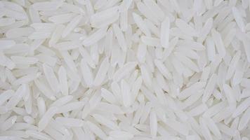 organic white raw jasmine- basmati rice background, white long seeds. macro closeup. as picture backdrop or background pattern texture photo