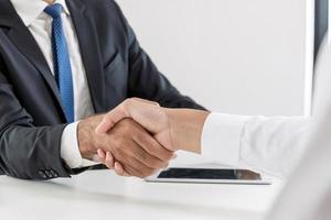 Contractor. two business people shaking hand after business signing contract in meeting room at company office, job interview, investor, success, negotiation, partnership, teamwork, financial concept photo