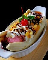Delicious Fruit Salad With Ice Cream. fresh fruits and nuts, topped with scoops of ice cream and chocolate. photo