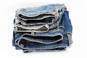 Blue jeans isolated on white background, jeans stacked photo