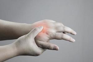 Examination and massage of hands to relieve red palm injuries. health care concept. Fractures of the metacarpal bones, rheumatism, carpal tunnel, Parkinson's disease photo