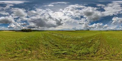 full seamless hdri 360 panorama among farming field with cut grass and clouds in overcast sky in equirectangular spherical projection, ready for use as sky replacement in drone panoramas or VR content photo