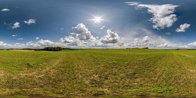 full seamless 360 hdri panorama view among farming field with sun and clouds in overcast sky in equirectangular spherical projection, ready for use as sky replacement in drone panoramas or VR content photo