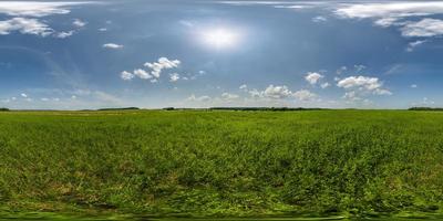 full seamless 360 hdri panorama view among farming field with sun and clouds in overcast sky in equirectangular spherical projection, ready for use as sky replacement in drone panoramas or VR content photo