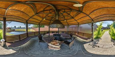 360 seamless hdri panorama view inside gazebo near river or lake with fireplace, table and chairs in equirectangular spherical projection, ready AR VR virtual reality content photo