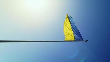 Slow motion flag of Ukraine waving in the wind against the sky. Ukrainian national symbol of the country is blue and yellow. Flag loop with detailed fabric texture. vertical video. photo