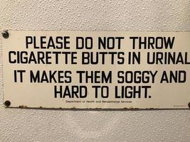 Toilet sign about cigarette butts photo