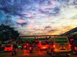 Jakarta, Indonesia in July 2022. Dusk on the road in Jakarta, where the traffic is quite congested because it coincides with work hours. photo