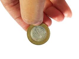 Turkey in June 2022. Isolated white photo of a hand holding a Turkish one lira coin.